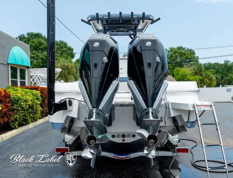 Slide: The Image of 2025 Caymas 281 HB boat with dual outboard motors, displayed at Black Label Marine Group. - 3