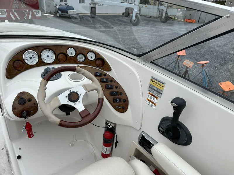 Slide: The Image of 2004 Starcraft Aurora 2410 boat dashboard with steering wheel and control panel. - 4