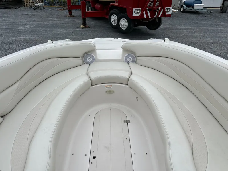 Slide: The Image of 2004 Starcraft Aurora 2410 boat interior with white seating and speakers. - 6