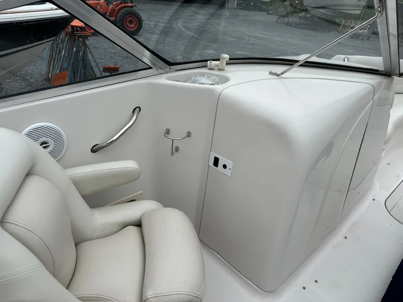 Slide: The Image of 2004 Starcraft Aurora 2410 boat interior with white seating and control panel. - 7