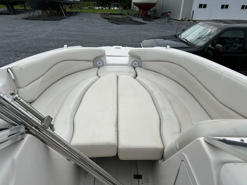 Slide: The Image of 2004 Starcraft Aurora 2410 boat interior with white cushioned seating. - 8