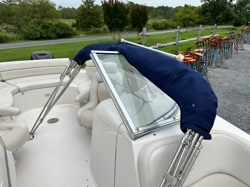 Slide: The Image of 2004 Starcraft Aurora 2410 boat interior with blue canopy and white seating. - 9