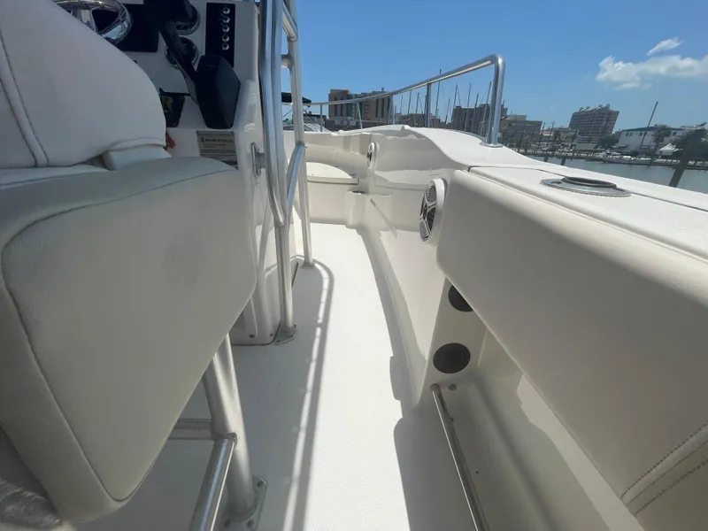Slide: The Image of 2016 Robalo R200 Center Console boat interior with white seating and railing. - 17