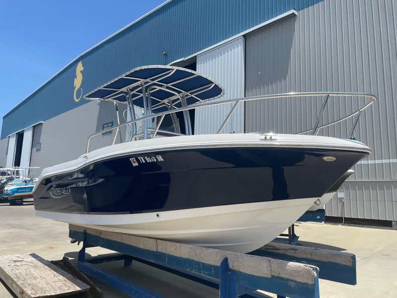 Slide: The Image of 2016 Robalo R200 Center Console boat on display outside a warehouse. - 2