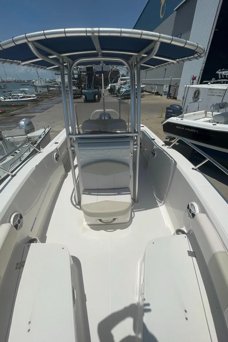 Slide: The Image of 2016 Robalo R200 Center Console boat with T-top in marina setting. - 23