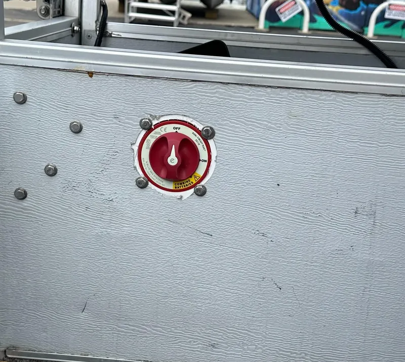 Slide: The Image of Red switch on a 1990 Crest III panel, surrounded by metal bolts. - 16