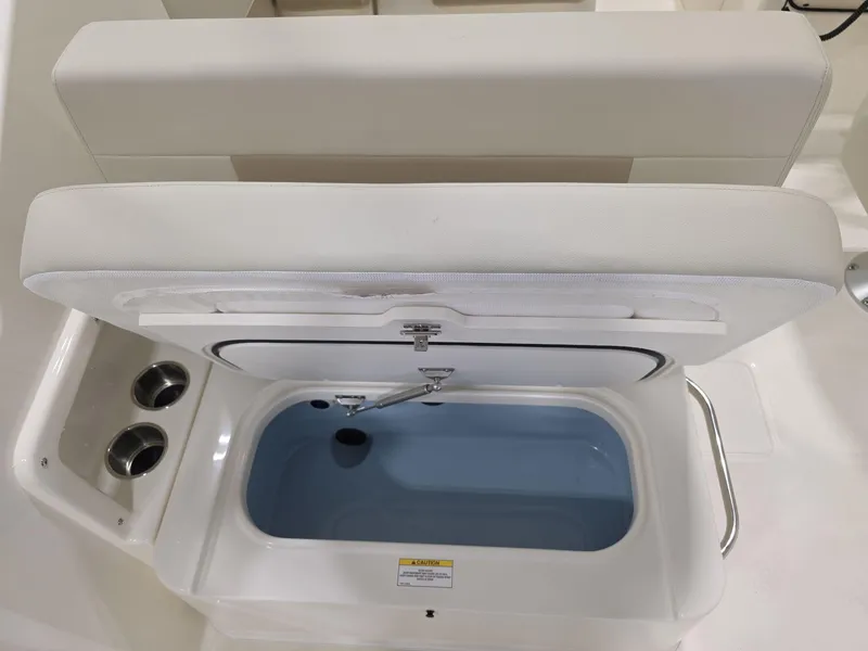 Slide: The Image of 2025 Boston Whaler 210 Vantage boat interior with open storage compartment. - 11