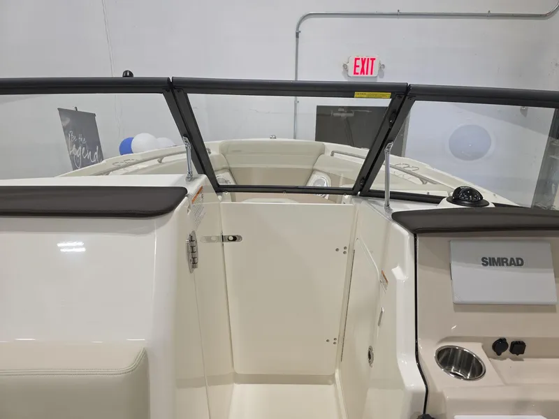 Slide: The Image of 2025 Boston Whaler 210 Vantage boat interior with Simrad display and windshield. - 15