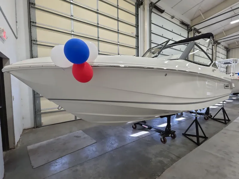 Slide: The Image of 2025 Boston Whaler 210 Vantage boat in showroom with decorative balloons. - 2