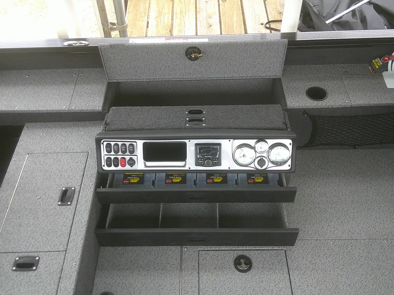 Slide: The Image of 2024 Lund 2075 Pro Guide boat dashboard with gauges and storage compartments. - 5