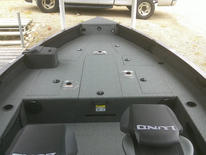 Slide: The Image of 2024 Lund 2075 Pro Guide boat interior with seating and storage compartments. - 8