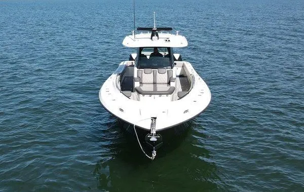 The Image of 2017 HCB Speciale boat on calm water, surrounded by lush greenery. - 0