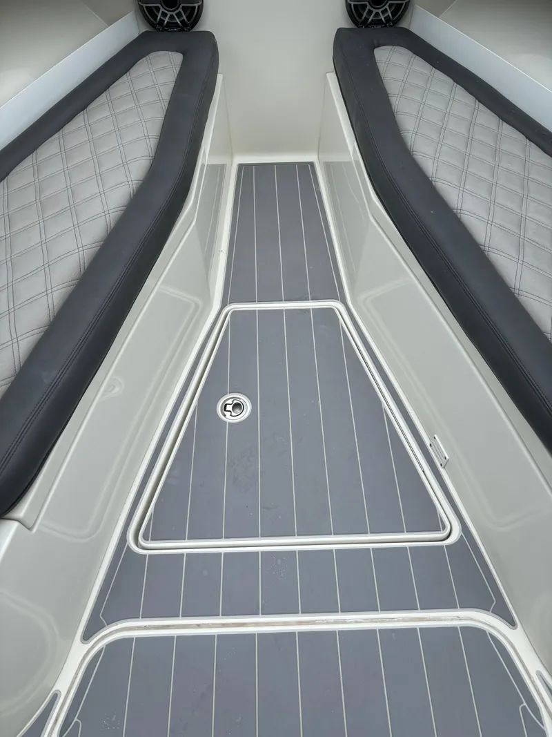 Slide: The Image of Four powerful outboard motors on a 2017 HCB Speciale boat, parked beside another vessel. - 37