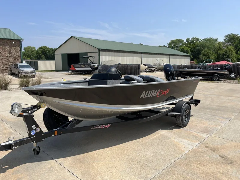 Slide: The Image of 2024 Alumacraft Classic 165 CS boat on trailer in outdoor setting. - 3