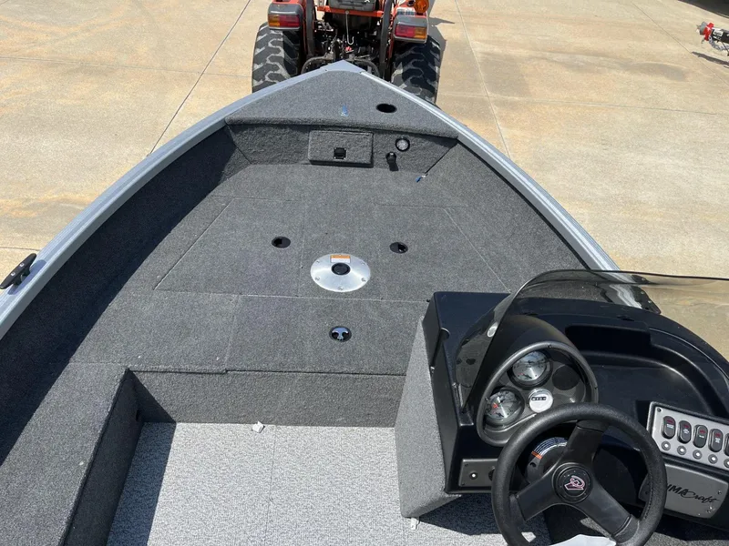 Slide: The Image of 2024 Alumacraft Classic 165 CS boat interior with steering console and spacious deck. - 5