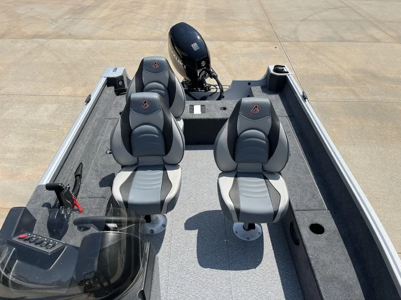 Slide: The Image of 2024 Alumacraft Classic 165 CS boat interior with two seats and motor. - 7