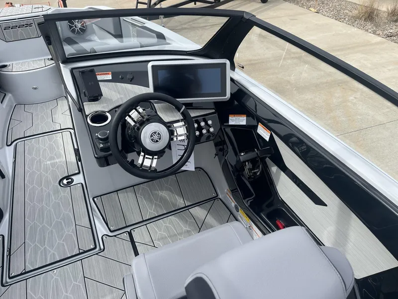 Slide: The Image of 2024 Yamaha Boats 222XD cockpit with modern steering and dashboard controls. - 7