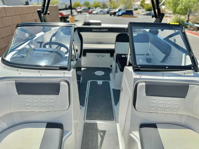 Slide: The Image of 2021 Bayliner VR5 Bowrider I/O interior with dual consoles and seating. - 10