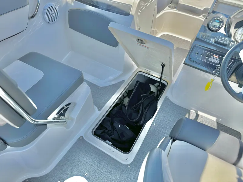 Slide: The Image of 2021 Bayliner VR5 Bowrider I/O interior with open storage compartment and seating. - 14