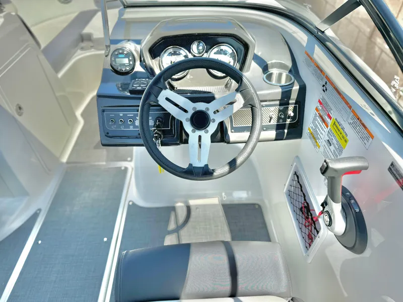 Slide: The Image of 2021 Bayliner VR5 Bowrider I/O dashboard with steering wheel and controls. - 16