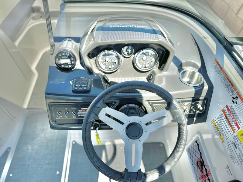 Slide: The Image of 2021 Bayliner VR5 Bowrider I/O dashboard with steering wheel and gauges. - 17