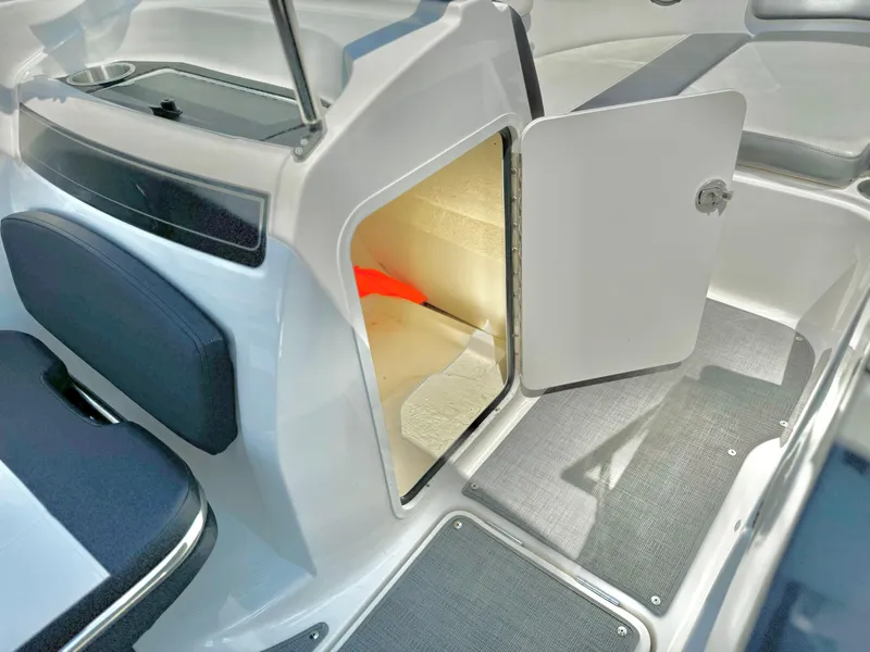 Slide: The Image of 2021 Bayliner VR5 Bowrider I/O interior storage compartment with open door. - 18