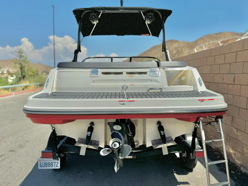 Slide: The Image of 2021 Bayliner VR5 Bowrider I/O boat, rear view, parked on a sunny day. - 2