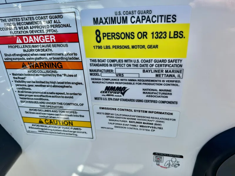 Slide: The Image of Capacity label for 2021 Bayliner VR5 Bowrider I/O, max 8 persons or 1323 lbs. - 24