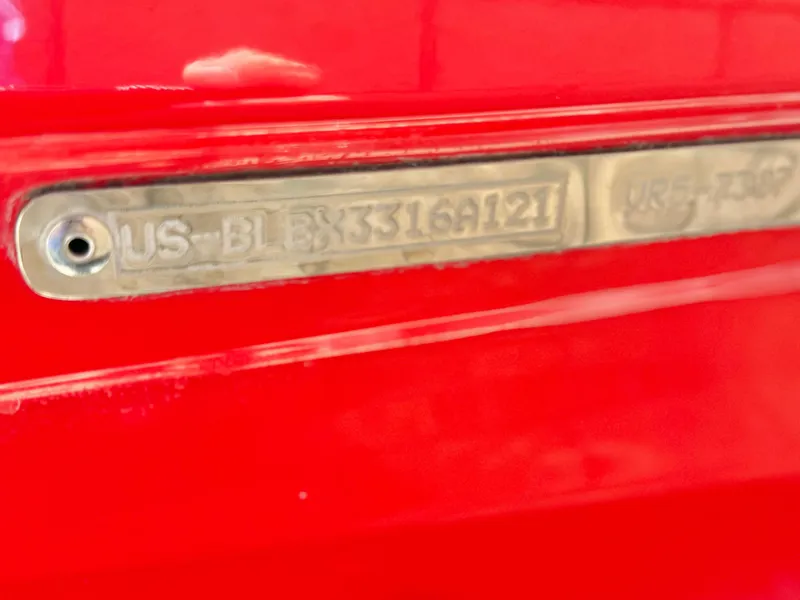 Slide: The Image of 2021 Bayliner VR5 Bowrider I/O hull identification number on red surface. - 25