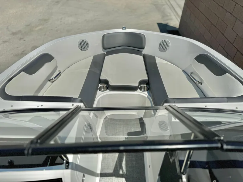 Slide: The Image of 2021 Bayliner VR5 Bowrider I/O boat interior with cushioned seating and speakers. - 8