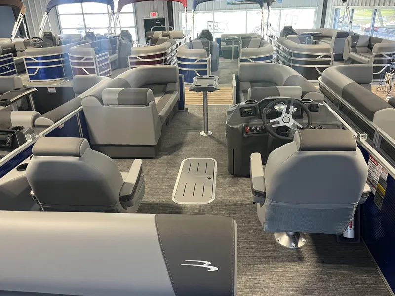 Slide: The Image of 2024 Bennington 20 SVSB-SPS pontoon boat interior with gray seating and steering console. - 4