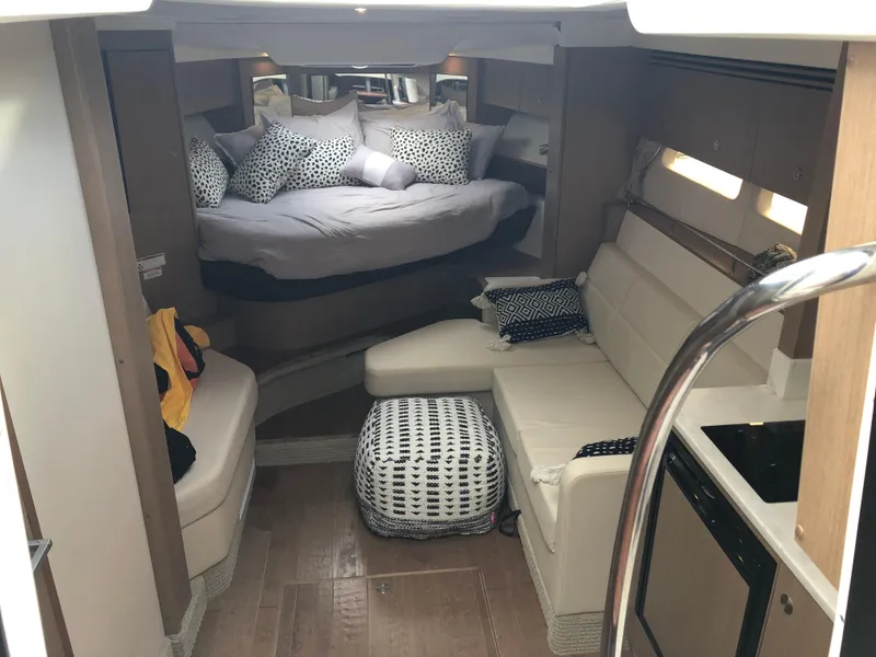 Slide: The Image of Interior of 2018 Sea Ray 350 Sundancer Coupe with cozy seating and bed area. - 14
