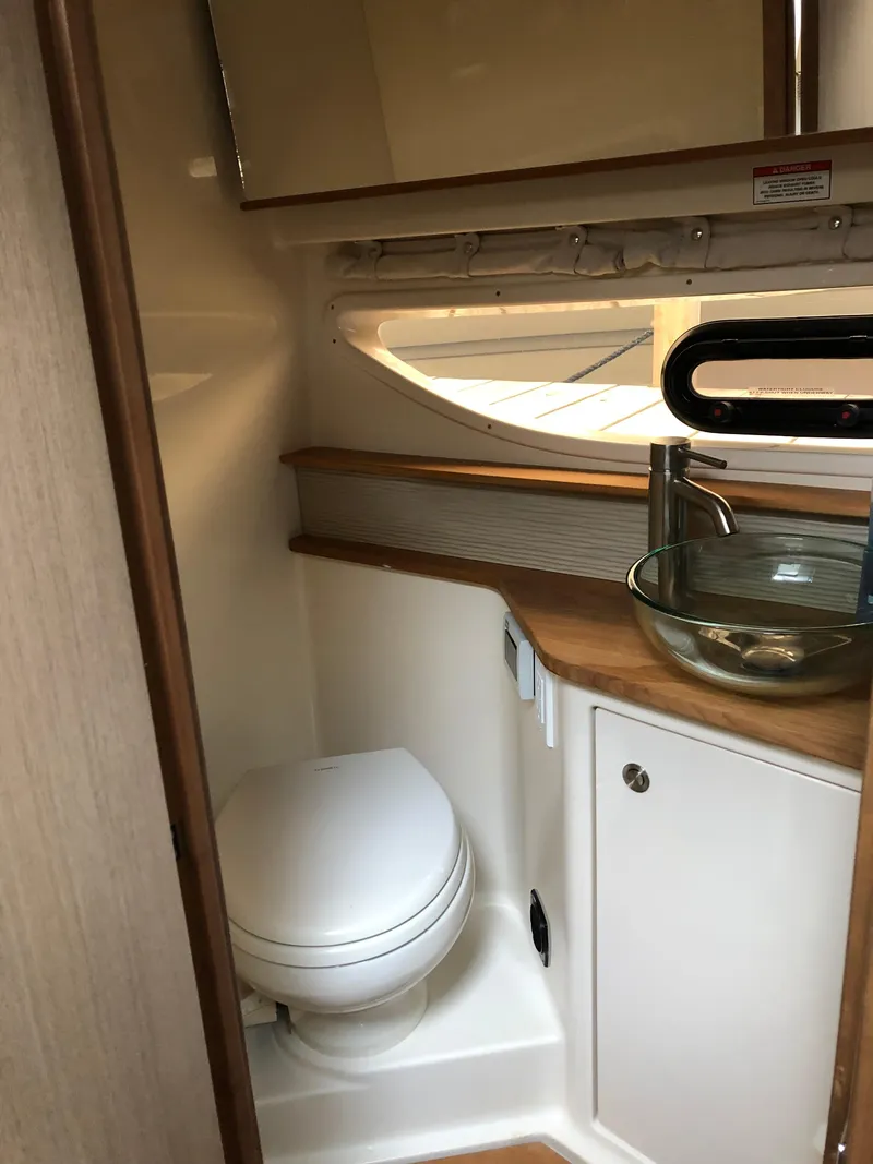 Slide: The Image of 2018 Sea Ray 350 Sundancer Coupe bathroom with modern sink and toilet. - 17