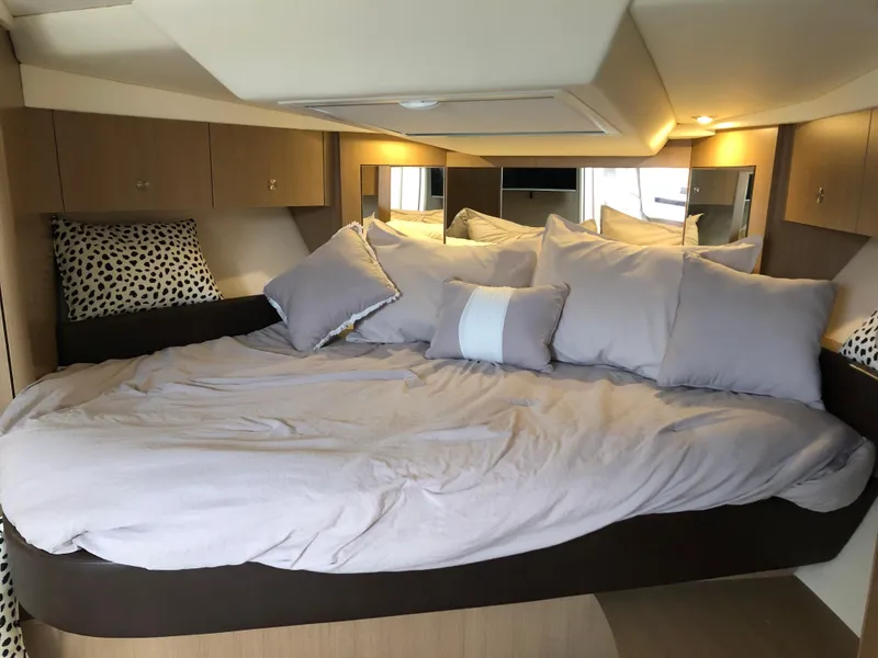 Slide: The Image of Luxurious cabin interior of 2018 Sea Ray 350 Sundancer Coupe with plush bedding. - 21