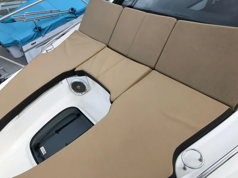 Slide: The Image of 2018 Sea Ray 350 Sundancer Coupe with beige sunpad and speaker on deck. - 22