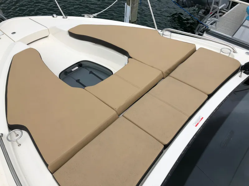 Slide: The Image of 2018 Sea Ray 350 Sundancer Coupe with tan sunbathing cushions on deck. - 23