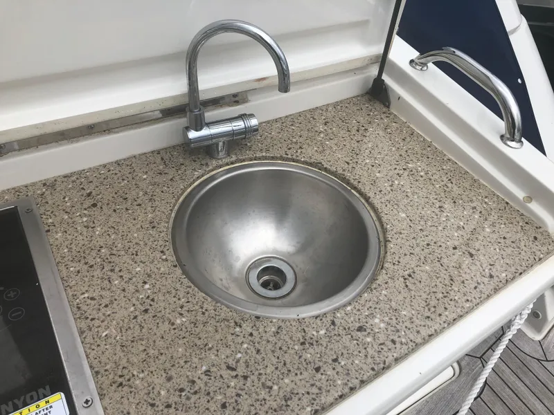 Slide: The Image of Outdoor sink on 2018 Sea Ray 350 Sundancer Coupe boat with granite countertop. - 25