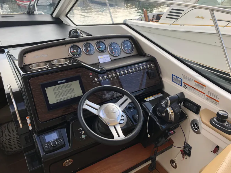 Slide: The Image of 2018 Sea Ray 350 Sundancer Coupe helm with modern controls and navigation system. - 7