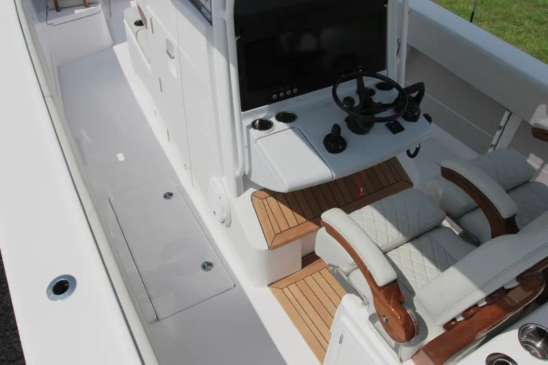 Slide: The Image of 2025 Jupiter 380LS boat interior with helm, seating, and teak flooring. - 11