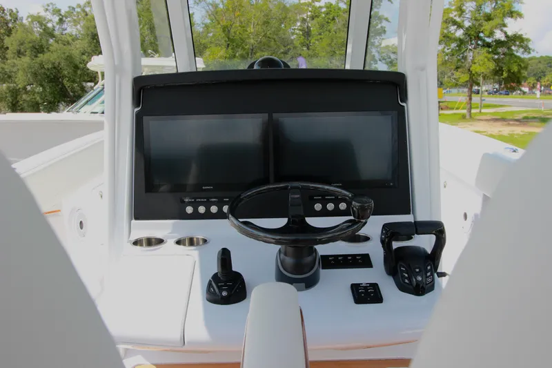 Slide: The Image of 2025 Jupiter 380LS boat dashboard with dual screens and steering wheel. - 13
