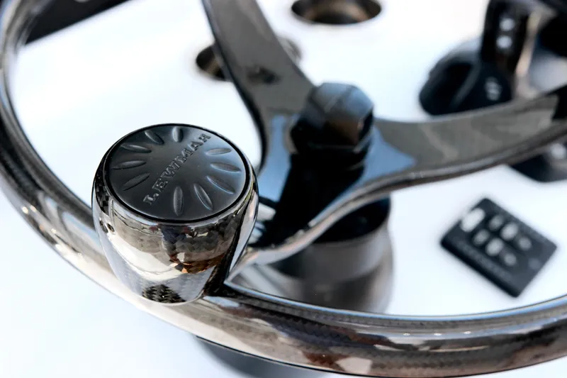 Slide: The Image of Steering wheel of 2025 Jupiter 380LS boat, featuring a sleek design and control knob. - 14