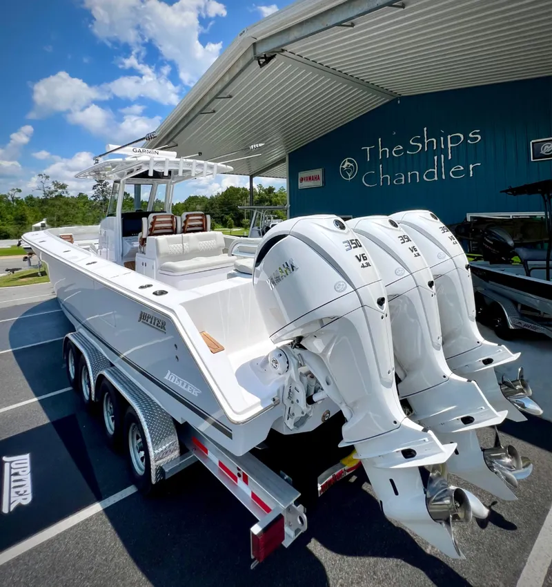 Slide: The Image of 2025 Jupiter 380LS boat with triple engines at The Ships Chandler dealership. - 2