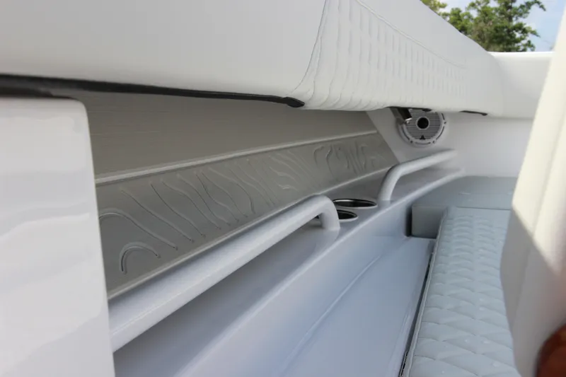 Slide: The Image of Interior of 2025 Jupiter 380LS boat, featuring sleek white seating and built-in cup holders. - 23