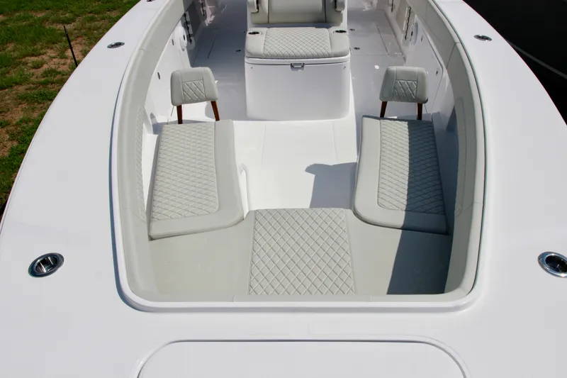 Slide: The Image of 2025 Jupiter 380LS boat interior with cushioned seating and sleek design. - 25