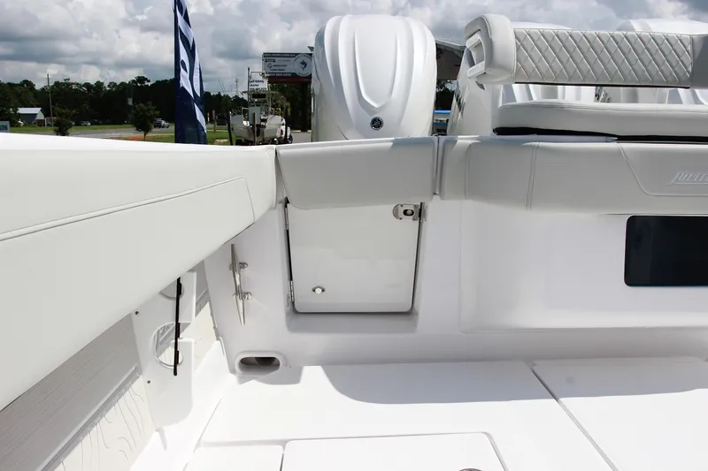 Slide: The Image of 2025 Jupiter 380LS boat interior with white seating and storage compartment. - 7