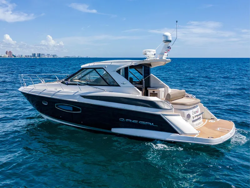 Slide: The Image of 2015 Regal 42 Sport Coupe yacht cruising on open sea. - 1