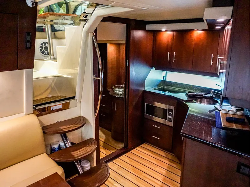 Slide: The Image of Luxurious interior of 2015 Regal 42 Sport Coupe yacht with modern kitchen and seating area. - 11