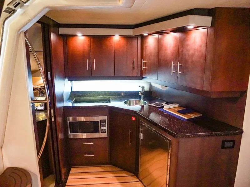 Slide: The Image of Luxurious 2015 Regal 42 Sport Coupe yacht kitchen with modern cabinetry and appliances. - 12