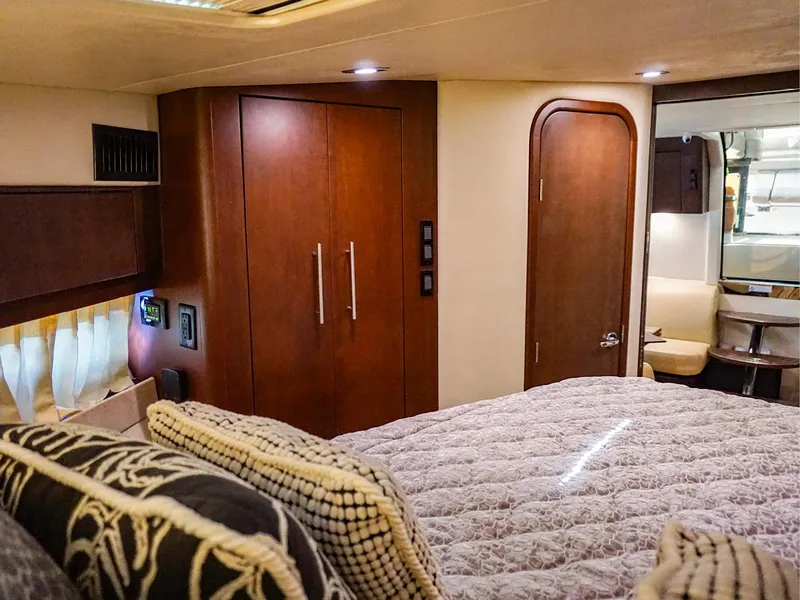 Slide: The Image of Luxurious interior of 2015 Regal 42 Sport Coupe with cozy bedding and elegant wood finishes. - 16