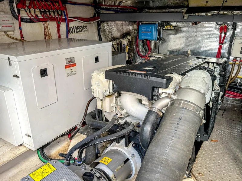 Slide: The Image of Engine room of 2015 Regal 42 Sport Coupe with visible machinery and wiring. - 21